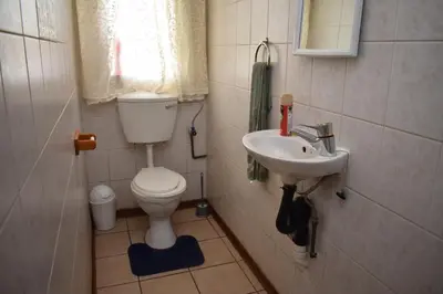 a small bathroom with a toilet and a sink at 39 on Clarendon in Graskop