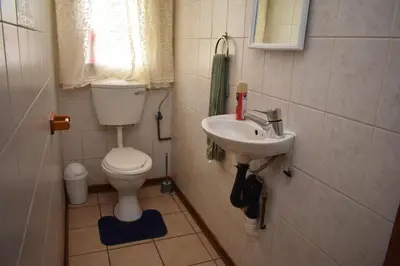 a small bathroom with a toilet and a sink at 39 on Clarendon in Graskop