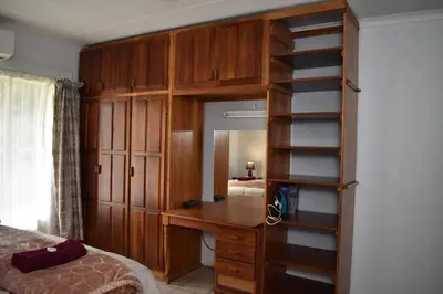 a bedroom with a desk and a book shelf at 39 on Clarendon in Graskop