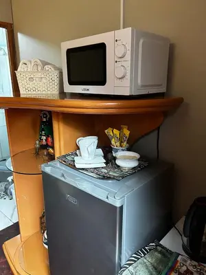 a microwave sitting on top of a refrigerator at Garden Studio in Waterkloof Ridge in Pretoria