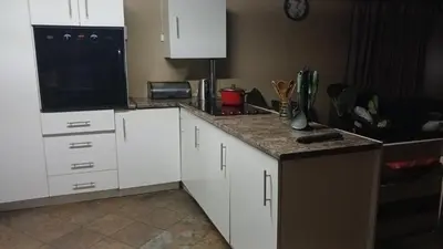 a kitchen with white cabinets and a counter top at 329 on 30th Avenue Villieria Juane in Pretoria