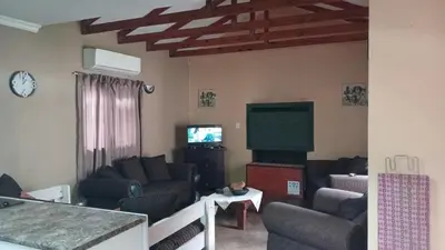 a living room with couches and a flat screen tv at 329 on 30th Avenue Villieria Juane in Pretoria
