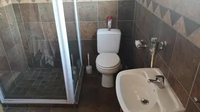 a bathroom with a toilet and a shower and a sink at 329 on 30th Avenue Villieria Juane in Pretoria
