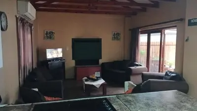 a living room with couches and a flat screen tv at 329 on 30th Avenue Villieria Juane in Pretoria