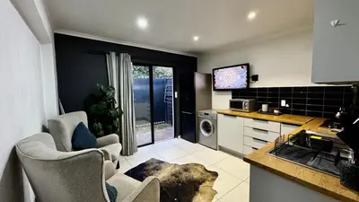 a kitchen with two chairs and a counter in a kitchen at Micro Urban Oasis 1 in Pretoria