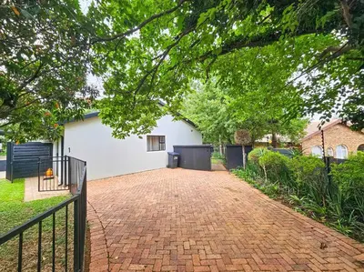 a brick driveway in front of a white house at Micro Urban Oasis 1 in Pretoria