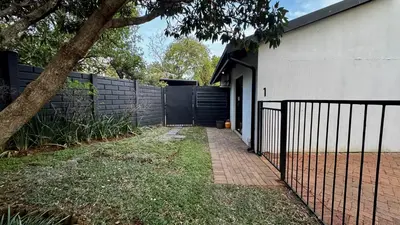 a fence in front of a house with a gate at Micro Urban Oasis 1 in Pretoria