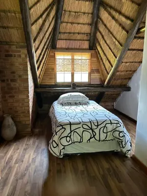 a bedroom with a bed in a attic at Okgethilwe Lodge in Sabie