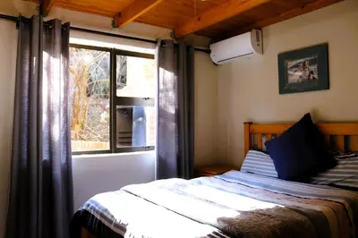 a bedroom with a bed and a window at Meerrus Self-Catering Home in Lake Chrissie
