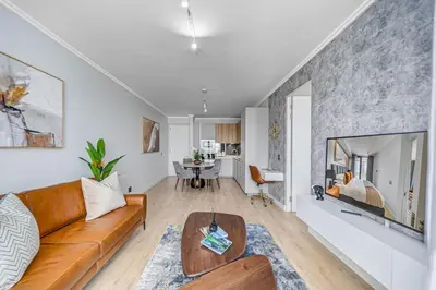 a living room with a couch and a table at Lumina on 8th in Midrand