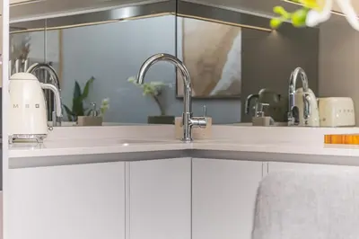 a kitchen with two sinks and two faucets at Lumina on 8th in Midrand