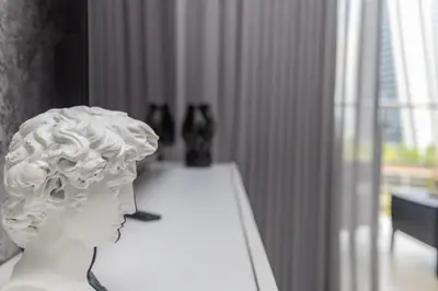 a white head statue sitting on a table in a room at Lumina on 8th in Midrand
