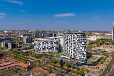 an aerial view of a city with tall buildings at Lumina on 8th in Midrand