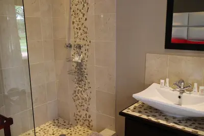 a bathroom with a sink and a shower at Cu Guest House in Phalaborwa