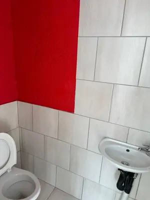 a bathroom with a toilet and a sink at Township Lodge -Seshego in Polokwane