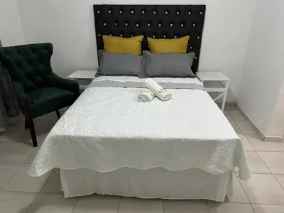 a bedroom with a bed with two towels on it at Township Lodge -Seshego in Polokwane