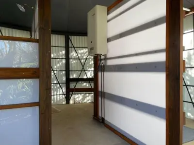 a room with a white garage door and some windows at Eindelik on Setlaars in Graskop