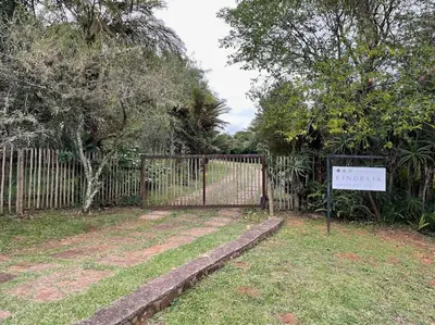 a gate with a sign in front of a fence at Eindelik on Setlaars in Graskop