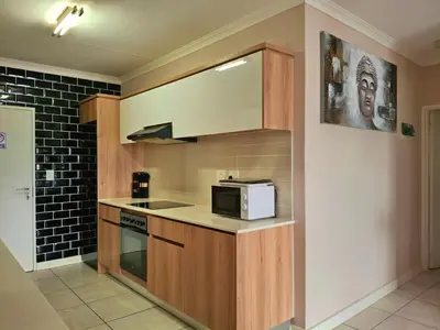 a kitchen with a microwave and a stove top oven at The Blyde Couple Suite in Pretoria