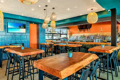a restaurant with wooden tables and bar stools at The Blyde Couple Suite in Pretoria