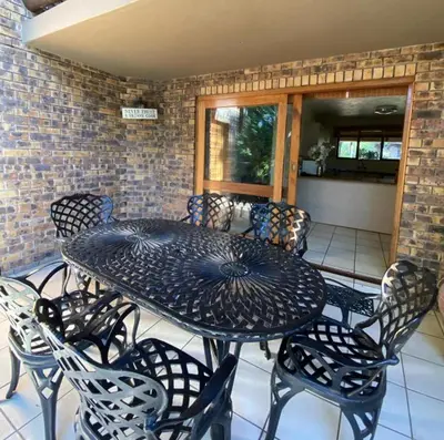 a black table and chairs on a patio at Kruger Park Lodge - Unit 522 , Hazyview in Hazyview