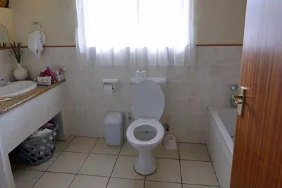 a bathroom with a toilet and a tub and a sink at Kruger Park Lodge - Unit 522 , Hazyview in Hazyview