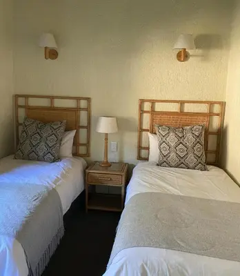 a room with two beds and a table with a lamp at Kruger Park Lodge - Unit 522 , Hazyview in Hazyview
