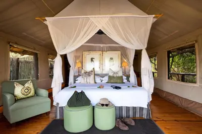 a bedroom with a large bed with a canopy at Pafuri Camp by RETURN Africa in Makuleke Contract Park