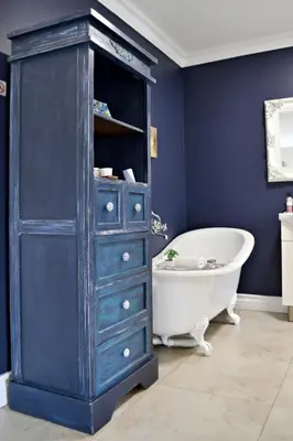 a bathroom with a blue cabinet and a bath tub at Bokmakierie Gastehuis Emalahleni Pty Ltd in Witbank