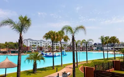 a view of the pool at a resort with palm trees at The Blyde 1471 in Pretoria