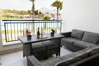 a living room with a couch and a table on a balcony at The Blyde 1471 in Pretoria