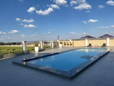 a swimming pool on the roof of a building at Lake view Apartment in Midrand