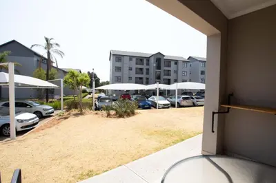 a view of a parking lot with cars parked at Mercy land Apartment 1 in Midrand