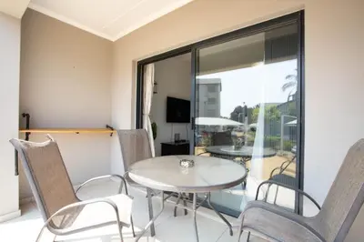 a dining room with a table and chairs at Mercy land Apartment 1 in Midrand