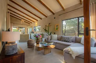 a living room with a couch and a table at The Duke Luxury Safari Villa, Huge Pool, Giraffe-Feeding-Tower, Outdoor Shower in Marloth Park