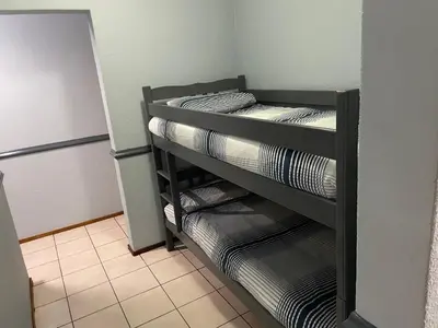 a room with three bunk beds in a refrigerator at Pendleberry Grove Unit 8 in Bela-Bela