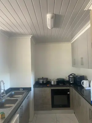 a kitchen with pots and pans on the counters at One Bedroom Apartment at Menlyn Place in Pretoria