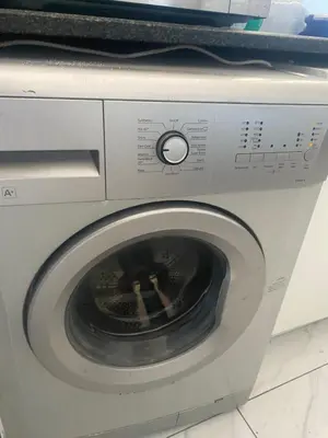 a washing machine with a microwave on top of it at One Bedroom Apartment at Menlyn Place in Pretoria
