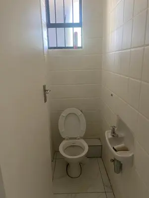a small bathroom with a toilet and a sink at One Bedroom Apartment at Menlyn Place in Pretoria