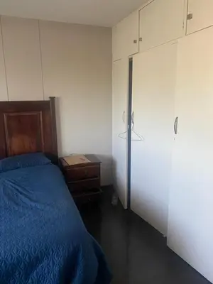 a bedroom with a bed and a dresser and a closet at One Bedroom Apartment at Menlyn Place in Pretoria