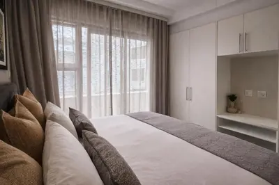 a bedroom with a bed and a large window at 522 The Regency Menlyn in Pretoria