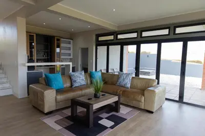a living room with a couch and a table at Mi Casa Su Casa Dullstroom luxury family Villa 12 sleeper in Dullstroom