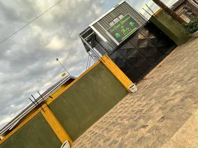 a building with a clock on the side of it at StayComfyGuesthouseByPunky in Soshanguve