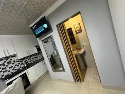 a bathroom with a sink and a mirror in a kitchen at StayComfyGuesthouseByPunky in Soshanguve