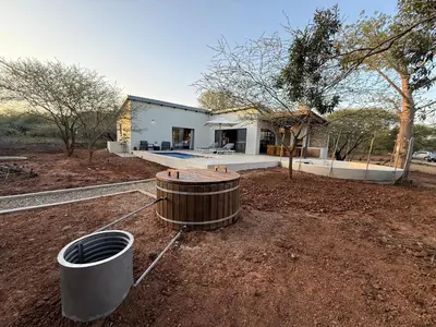 a house with a wooden tub in the yard at Pillows Luxury Safari Villa, Wood-Fired Hottub, Giraffe-Feeding-Tower, Large Private Pool in Marloth Park