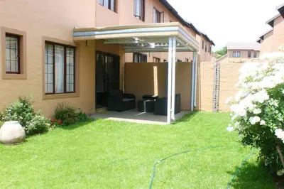 a pergola on the side of a house at cozy 3 bed Duplex ,sleeps 6 with double bathroom in Midrand