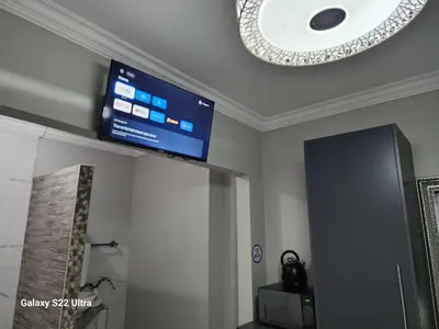 a flat screen tv on the ceiling of a room at Oblique Boutique House in Centurion