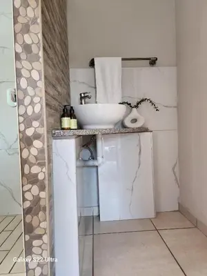 a bathroom with a sink and a toilet at Oblique Boutique House in Centurion