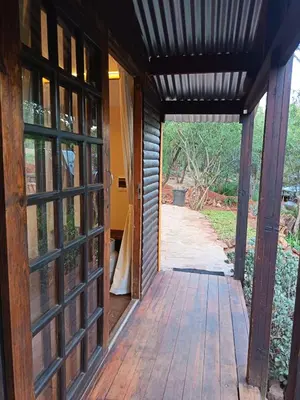an open door to a house with a porch at Koinonia Bush Lodge in Hartbeespoort