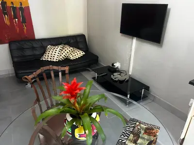 a living room with a glass table and a couch at Garden Studio 2 Waterkloof Ridge in Pretoria